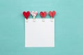 Red heart clip design with blank white paper on blue background Royalty Free Stock Photo