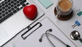 Red heart, clipboard, laptop computer and stethoscope on white background. Royalty Free Stock Photo