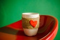 red heart on coffee cup on green background. valentine's day celebration concept. vintage filtered.Valentine's day Royalty Free Stock Photo