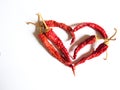 Red heart composed of red chili peppers on white background. Symbol of love Royalty Free Stock Photo