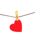 Red heart from dense fabric on a clothespeg on a rope