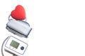 A red heart and a device for measuring heart pressure on a white background. The concept of health, heart disease Royalty Free Stock Photo