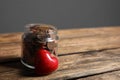 Red heart and donation jar with coins on table against grey background. Space for text Royalty Free Stock Photo