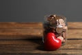 Red heart and donation jar with coins on table against grey background. Space for text Royalty Free Stock Photo