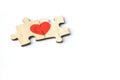 Red heart is drawn on the pieces of the wooden puzzle lying next to each other isolated on white background. Love concept. St. Royalty Free Stock Photo