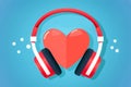 Red heart is embraced by a pair of headphones against a blue background