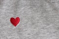 Red heart embroidered with threads on gray fabric background. Close-up, macro, copy space, flat lay. March 8, February 14, Royalty Free Stock Photo