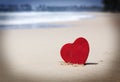 Red heart on exotic sandy beach