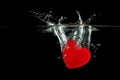 Red heart falling on water splashing. Royalty Free Stock Photo