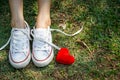 Red heart beside the foot Royalty Free Stock Photo