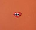 Red heart with funny toy eyes copy space Romance love and enjoy and have fun in the holidays concept