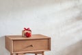 Red heart and gift box on bedside table. Valentine's day background Royalty Free Stock Photo