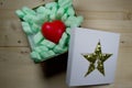 Red heart in gift box with golden star Royalty Free Stock Photo