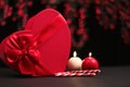 Red heart gift box and two candles, red bokeh in the background Valentines Day Royalty Free Stock Photo