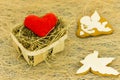 Red heart and ginger biscuits in the form of a cupid and a white dove. Wicker basket and cookies. Royalty Free Stock Photo
