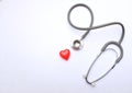 Top view red heart and gray stethoscope isolate on white doctor table.concept health check and a doctor`s office