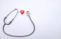 Top view red heart and gray stethoscope isolate on white doctor table.concept health check and a doctor`s office