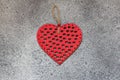 Red heart on a gray stone background. Close-up.