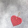 Red heart on a gray stone background. Top view.