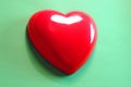 Red heart on green background, Showed  attention, unity, charity, care or love of human Royalty Free Stock Photo