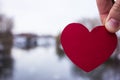 Red heart in the hand of the girl. river background Royalty Free Stock Photo