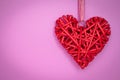 Red heart hand-made on a rope on pink background. Romantic gift card on valentines day. Symbol of love. Copy, text space. Holiday Royalty Free Stock Photo