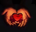 Red heart in hands. In heart hands. Love Hands Heart Background