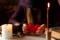 Red heart in hands of witch, love spell and broken heart, unrequited love. Psychic vision, fortune teller