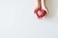 Red heart on hand woman on white blackground,Healthcare and cardiology concept,Top view and coppy space