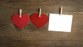 Red heart hanging on the clothesline for Valentine Day cards