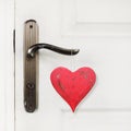 Red heart hanging on the door handle