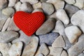 Red heart on a heap of stones
