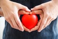 Red heart held by male and female`s both hands, represent helping hands, help each other, love, partnership, sympathy, customer an Royalty Free Stock Photo