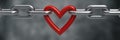 Red heart held by a steel chain background