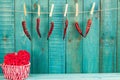 Red heart and hot chili pepper on wooden background. Holidays background. Valentines day background.