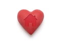 Red heart with imprinted house shape over white background