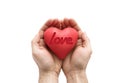 Red heart with imprinted love word in man`s hands.