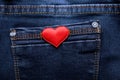 Red heart on jeans background