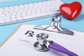 Red heart, keyboard and Medical stethoscope lying on cardiogram chart closeup. Medical help, prophylaxis, disease