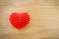 Red heart knit with yarn on wooden floor