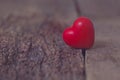 The red heart lies on the cracks of the tree. The separation, loneliness, love,vintage. Valentine`s Day.