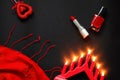 Red heart and lipstick, on a black background, a string of white pearls and a silk handkerchief Royalty Free Stock Photo