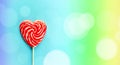 Red heart lollipop on rainbow background, love and Valentine day banner Royalty Free Stock Photo