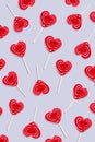 Red heart lollipops pattern on grey background