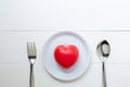 Red Heart with love and dish and spoon and fork on wooden background Royalty Free Stock Photo