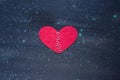 Red heart made of cloth with white thread on a black background, the Concept of Sadness, unrequited love, a broken heart Royalty Free Stock Photo