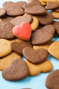 Red heart made of glazed gingerbread over a bunch of cookies