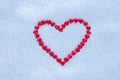 Red heart made with lots of little hearts on the center of snow background. Royalty Free Stock Photo