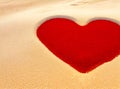 A red heart made out of sand on beach, of sand background. With space for text. Generative AI Royalty Free Stock Photo