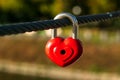 Red heart on a metal cable on bridge. Padlock of shape of heart on a rope. Romantic concept. Symbol of love. Royalty Free Stock Photo